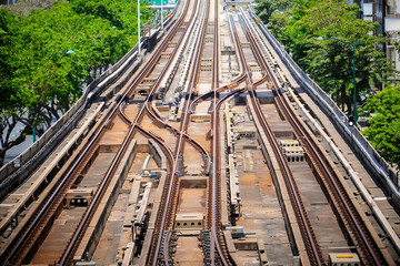 Top aerial view of the railway tracks and railway switches at the distribution station next to the train depot. Looking into the distance perspective