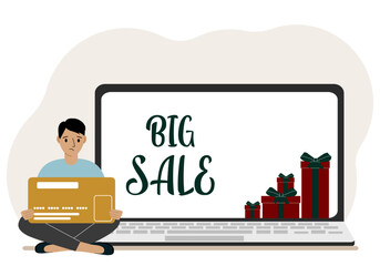 Online shopping. Big sale. A man sits cross-legged in his hands holding a shopping card. Next to a laptop with gifts. Vector flat illustration