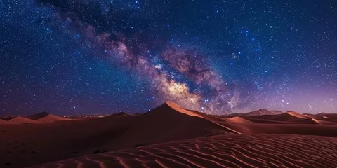 Foto op Canvas A desert landscape with a large hill and a large body of stars in the sky. The stars are scattered throughout the sky, creating a sense of vastness and emptiness © kiimoshi