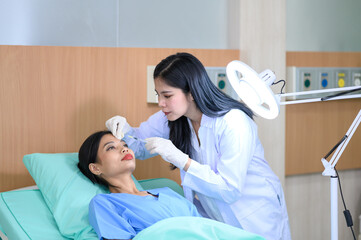 Woman doctor cosmetologist injects a filler into the cheek of the patient's woman. Cosmetology concept.