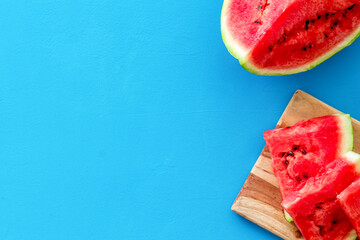 Cut watermelon for break with fruit on blue background top view mockup
