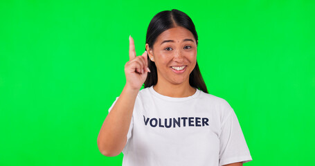 Volunteer, green screen and a woman pointing at space for advertising, charity or information. Face...