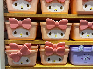 A row of stuffed animals are displayed on shelves.