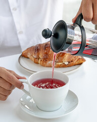 man in white shirt pours fruit tea in courasan background
