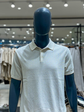 A mannequin is wearing a white shirt with a pocket