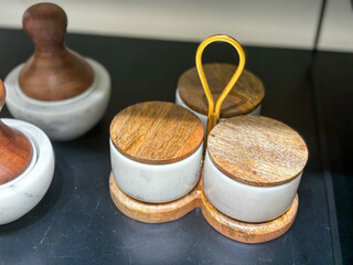 A wooden tray with three small bowls on it