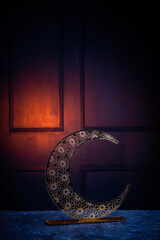 Golden crescent moon shape on the table with copy space for greeting text, Eid Mubarak background