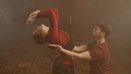 Professional dancers performing dance show. Young man and woman contemporary dancers perform modern...