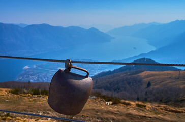 The Swiss cowbell against the hazy Alps and Lake Maggiore, Ticino, Switzerland