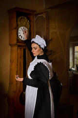 Victorian maid adjusting antique clock