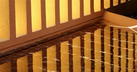 Patterns of architecture orange pillars reflected in water