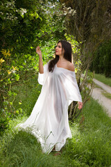 Woman in sheer backlit dress posing - 779849008