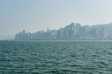January 01, 2024: Buildings on Victoria Harbour, Hong Kong, China. People celebrating Chinese new year and 2024. 