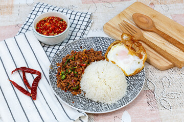 Traditional Thai street food, stir-fried minced beef with basil, chili, and garlic, served with a fried egg