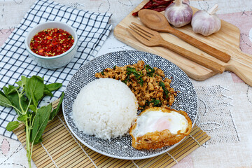 Traditional Thai street food, stir-fried minced chicken with basil, chili, and garlic, served with a fried egg