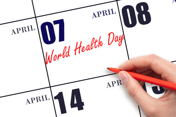 April 7. Hand writing text World Health Day on calendar date. Save the date.