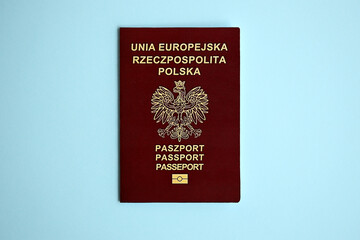 Poland passport on blue background close up. Tourism and citizenship concept
