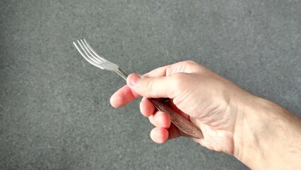 Man holding a metal fork in his hand