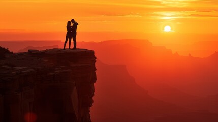 Silhouette of a couple standing on a cliff overlooking a sunrise love couple background