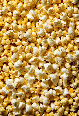 A scattering of popcorn in pop art style on a uniform bright background