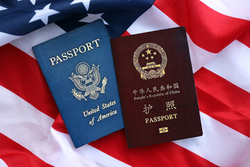 Passport of China Republic with US Passport on United States of America folded flag close up