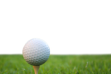 A golf ball sits on a golf tee on a green grass field.