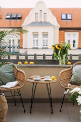 Selective focus on cozy place for rest on opened balcony with view on building.