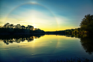 Unusual atmospheric phenomena. Very bright double halo (parhelic ring) over river at moment of...
