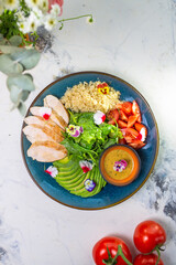 Healthy Lunch Plate With Grilled Chicken, Salad, Avocado, Couscous on Blue Plate