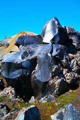 Obsidian, volcanic glass formed by rapid cooling of lava, with Brennisteinsalda volcano (855 m, the...