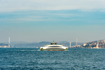 View of Bosphorus Bridge and ferries in Istanbul, Turkey.