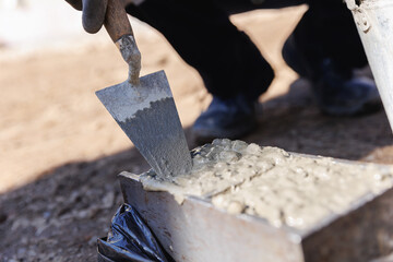 Worker making cube concrete casting by steel mould for control quality cement in building site