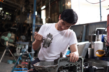 two professional male and female auto mechanic in auto repair shop. technician having automotive job to maintenance or repair automobile in motor garage, business industrial auto car engine.