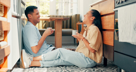 Talking, coffee and a happy couple at home with love, care and communication. Young woman and man laughing while drinking tea together to bond for happiness, quality time and conversation on a floor