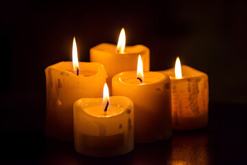 Group of litting candles isolated on black background