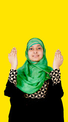 Muslim Woman Smiling and Praying with Arams Raised, Copy Space on Top