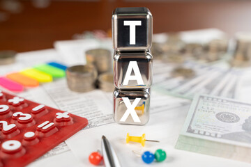 A stack of cubes with the word tax written on them.