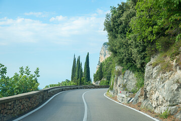 Driving on the winding Gardesana road between Limone and Gargnano, danger of rock falls