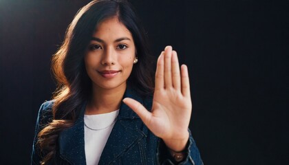 Close up of woman showing stop gesture with hand raising up on black background, young female protesting against domestic violence and abuse, bullying, saying no to gender discrimination  - Powered by Adobe