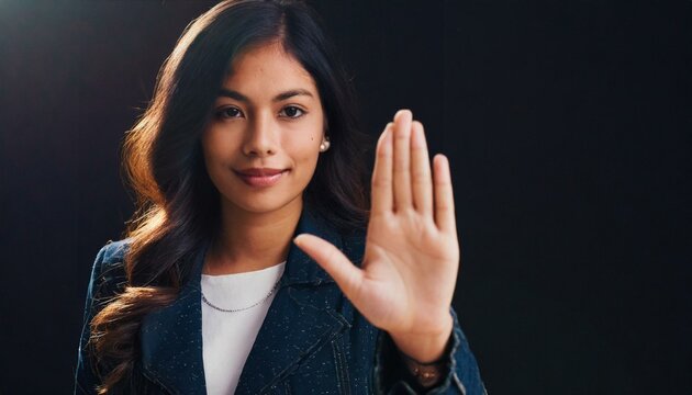 Close up of woman showing stop gesture with hand raising up on black background, young female protesting against domestic violence and abuse, bullying, saying no to gender discrimination