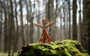 magic witchcraft doll made of tree bast in autumn forest, natural background. Forest grandmother, defender guardian spirit of nature. old pagan Wiccan, Slavic tradition. esoteric spiritual ritual - obrazy, fototapety, plakaty
