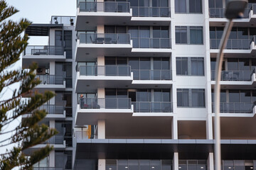Pre-teen boy standing on balcony of high rise apartment building on the Gold Coast