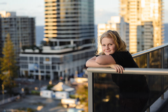 Pre-teen boy standing on balcony of high rise building on the Gold Coast