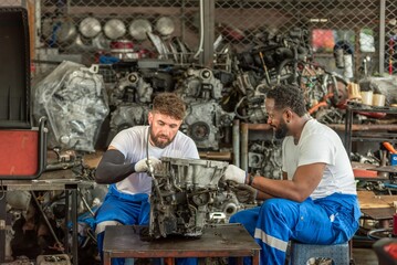 auto two professional mechanical technician garage motor car engine team check automobile engine...