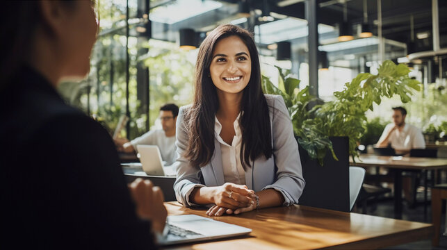 Portrait of young female girl having interview in open workspace, indian girl on job interview