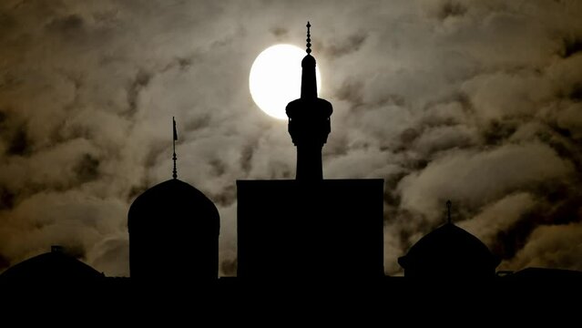 Mosque of Imam Reza By Night with Dark Atmosphere, Fog, Smoke, and Full Moon,  Mashhad, Iran