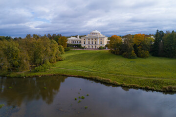 October landscape with Pavlovsk Palace on a cloudy day (shooting from a quadcopter). Suburbs of St. Petersburg, Russia