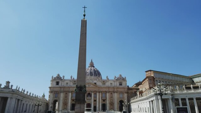 Amazing cinematic scene of Vatican on sunny day with view of Egyptian Obelisk  and Saint Peter basilica church at background in Rome, Italy