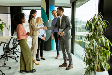 A warm handshake welcome during a sunny morning office gathering