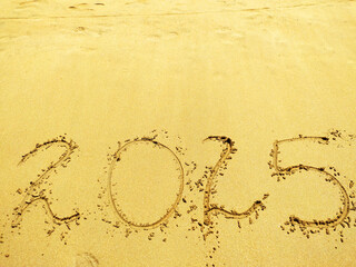 2025 number on a sand beach. Abstract background photo of coming New Year 2025
